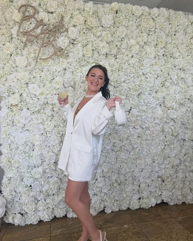 White rose flower wall at a pearls and Prosecco bridal shower