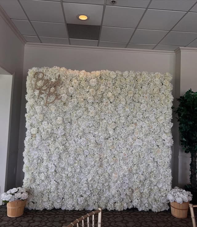 White flower wall at a country club bridal shower