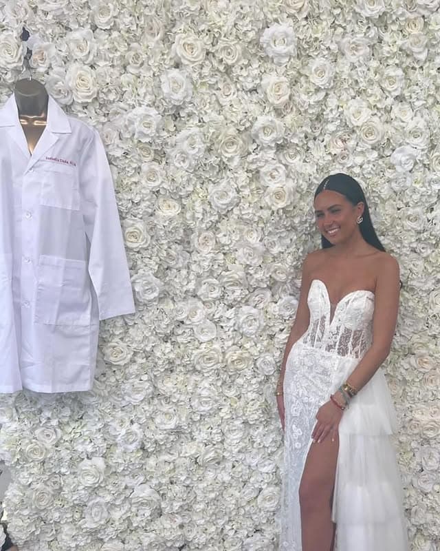 All-white graduation party with white rose flower wall